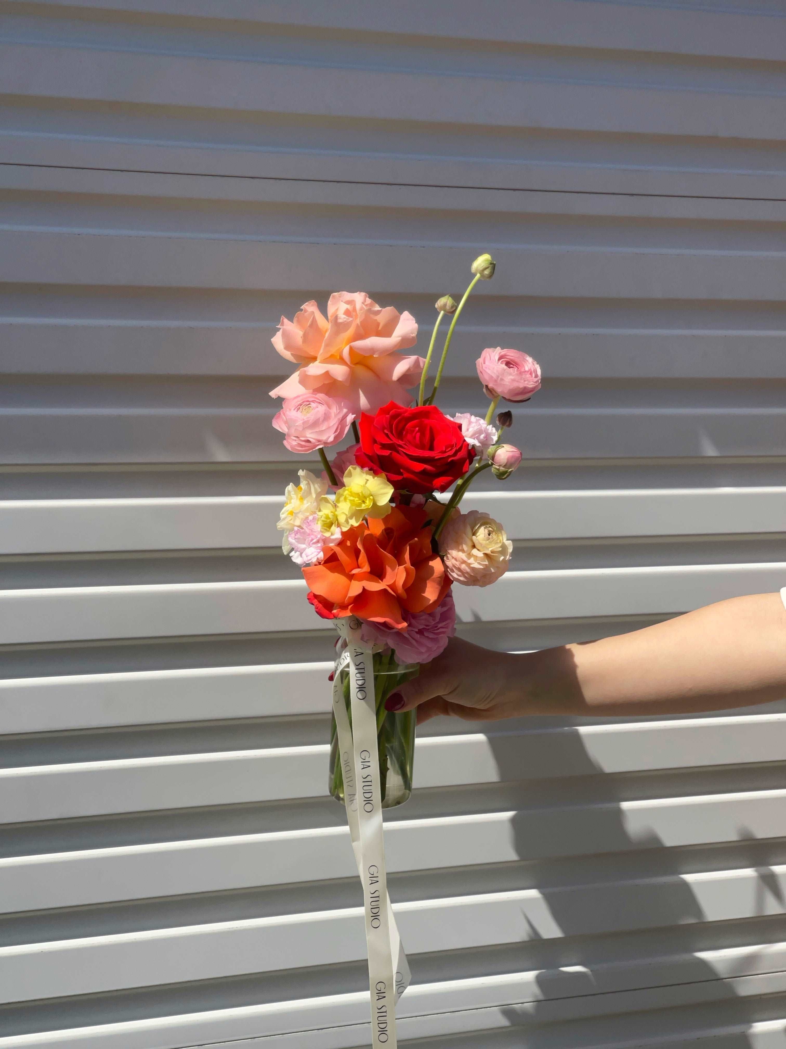 Gia Studio - Daily Vase with reflexed roses, tulips, and seasonal blooms in bubble vase. 