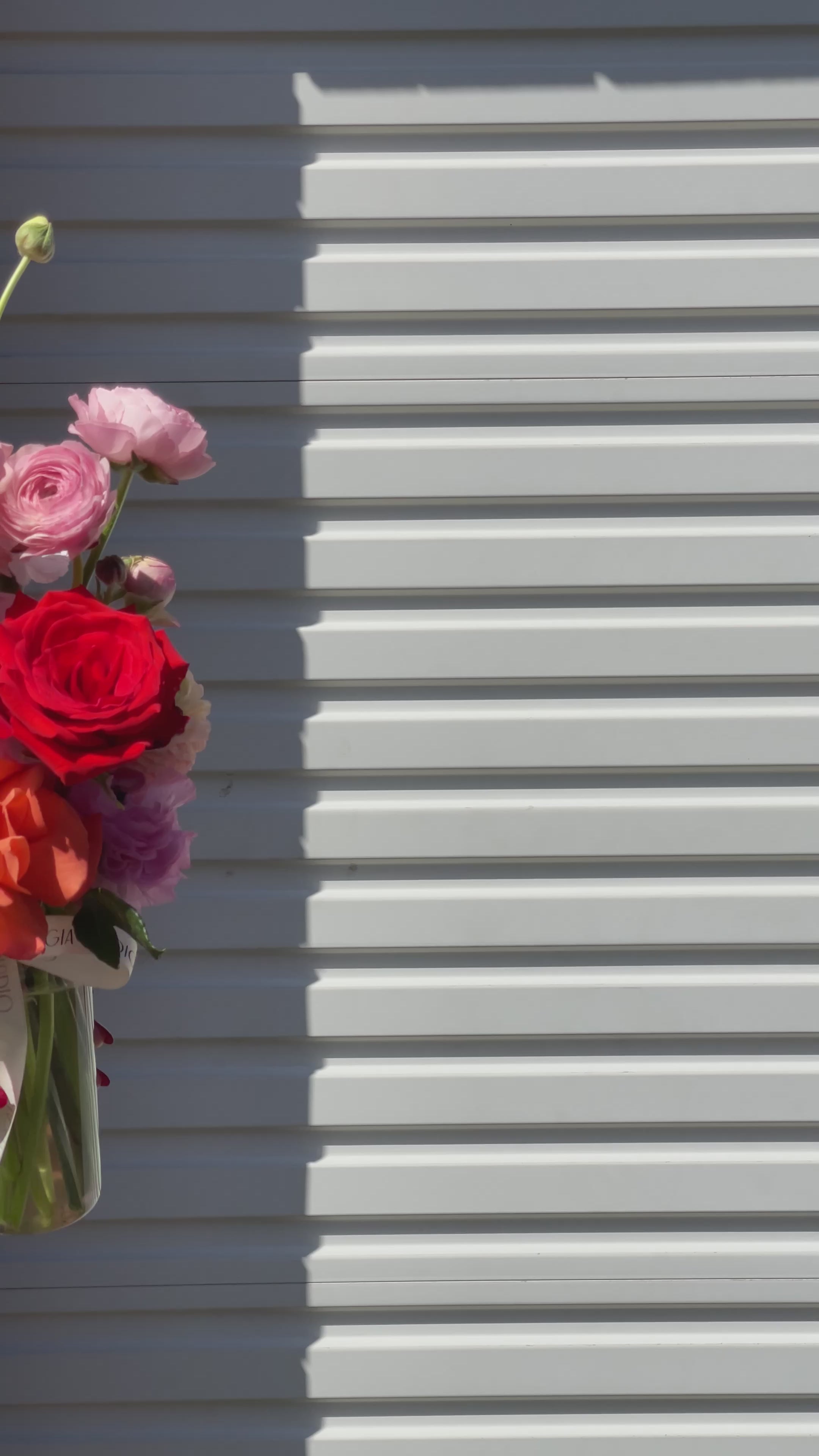 Gia Studio - Daily Vase with reflexed roses, tulips, and seasonal blooms in bubble vase. 