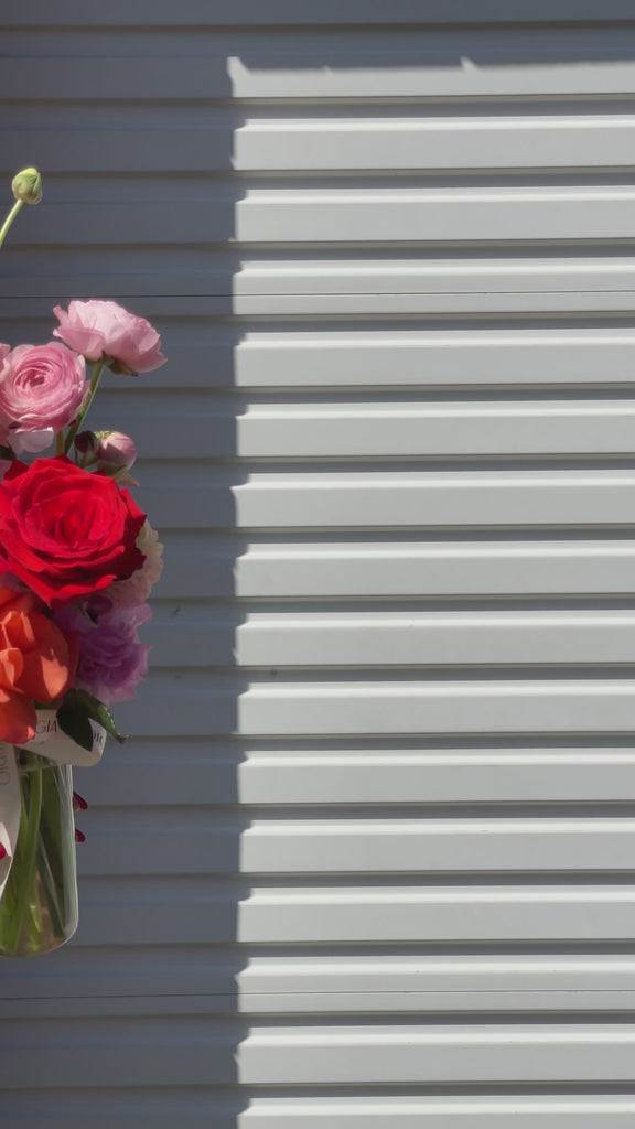 Gia Studio - Daily Vase with reflexed roses, tulips, and seasonal blooms in bubble vase. 